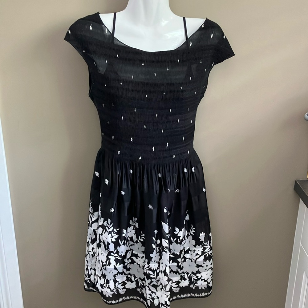 Cute little black dress with elastic stretch top of dress and gathered skirt.